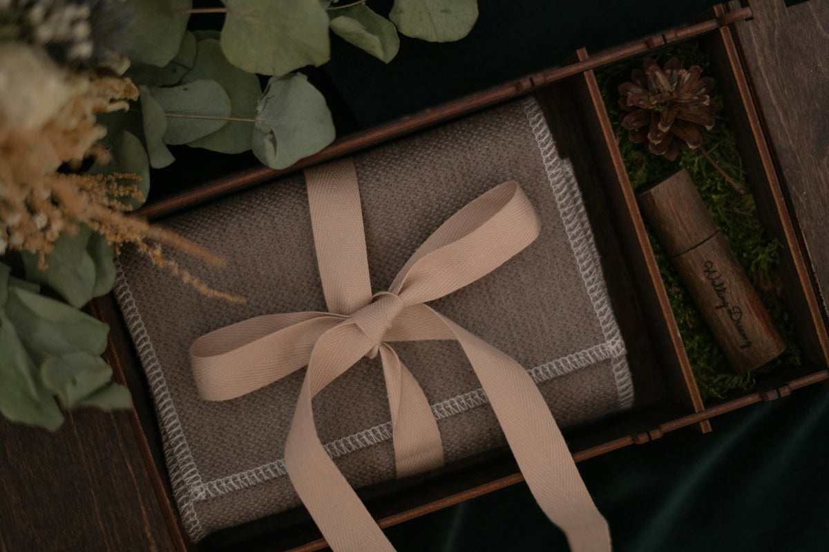 Gift box wrapped in brown paper and ribbon